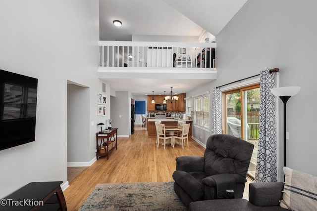 27W137 Chestnut Ln, Winfield, IL 60190 - living area with a high ceiling, an inviting chandelier, baseboards, and light wood finished floors