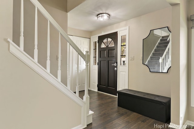 entrance foyer with stairs and dark wood-style flooring