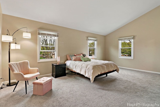 bedroom featuring carpet flooring, baseboards, and vaulted ceiling