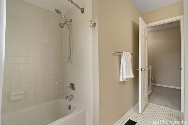 full bath with tile patterned flooring, baseboards, and washtub / shower combination