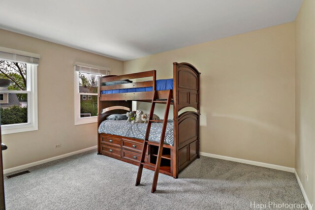 carpeted bedroom with baseboards