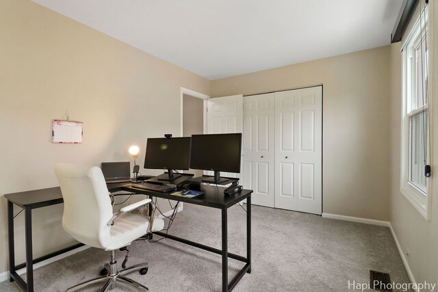 home office featuring light colored carpet and baseboards