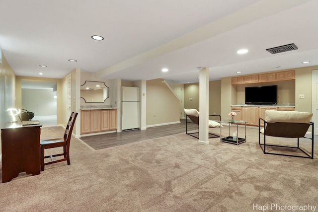 interior space with light carpet, recessed lighting, and baseboards