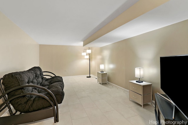 living area with baseboards and light tile patterned flooring