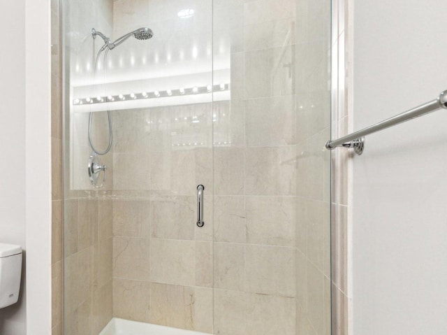full bathroom with toilet and a stall shower