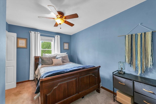 bedroom featuring baseboards, a ceiling fan, and light colored carpet