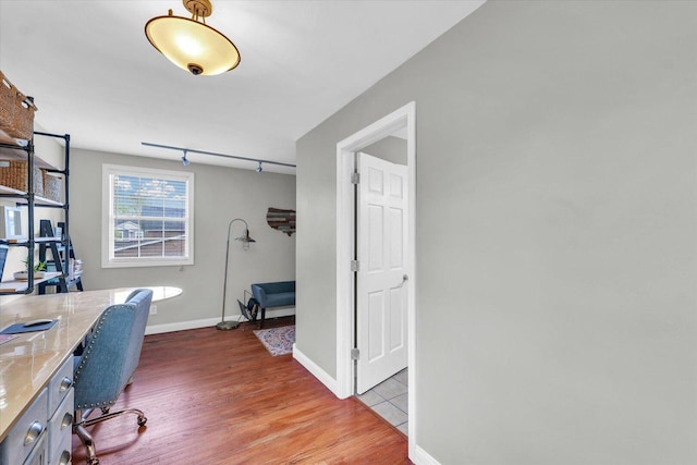 office area featuring baseboards and wood finished floors