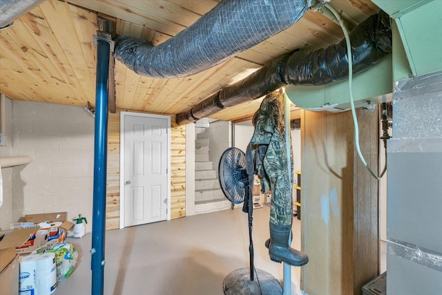 unfinished basement featuring concrete block wall
