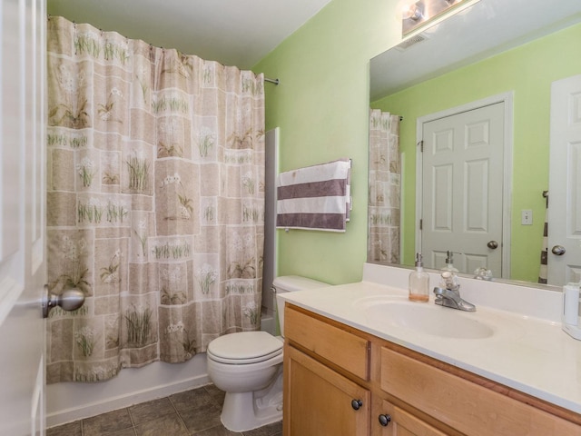 bathroom featuring tile patterned floors, toilet, vanity, visible vents, and shower / tub combo with curtain