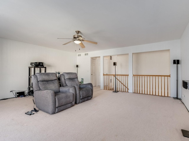 carpeted living area featuring a ceiling fan and visible vents