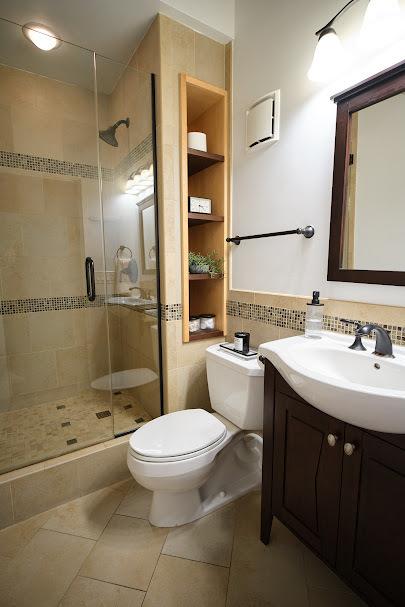 full bath featuring vanity, tile walls, toilet, and a shower stall