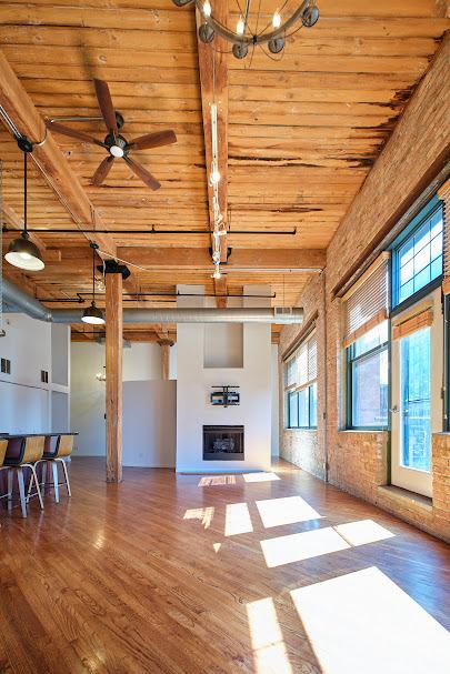 unfurnished living room featuring wood ceiling, plenty of natural light, ceiling fan with notable chandelier, and beam ceiling