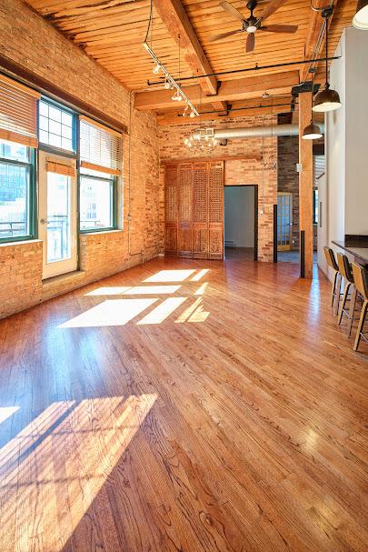 unfurnished living room with a ceiling fan, wood finished floors, track lighting, wooden ceiling, and beamed ceiling