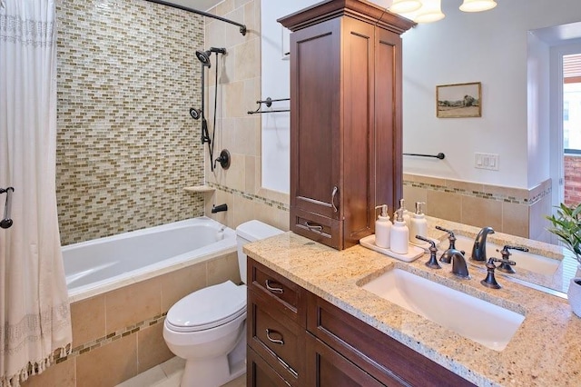 full bathroom with tiled shower / bath combo, toilet, and vanity