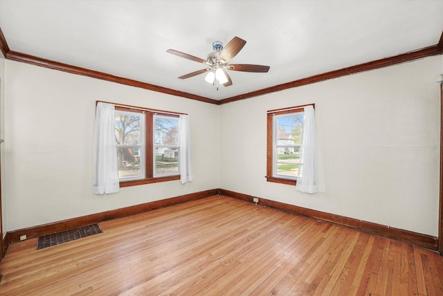 spare room with baseboards, visible vents, light wood-style floors, and plenty of natural light