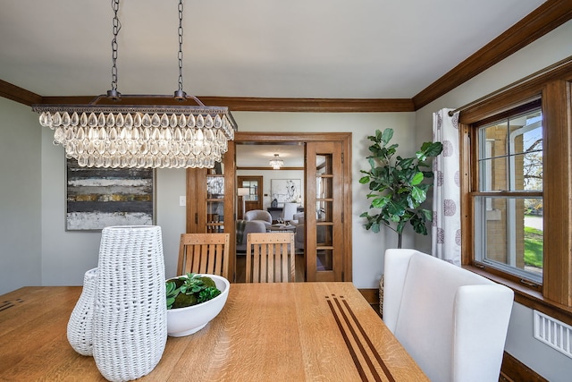 dining area featuring ornamental molding and a healthy amount of sunlight