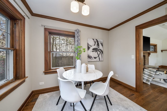 dining space with baseboards, a wealth of natural light, and dark wood-type flooring
