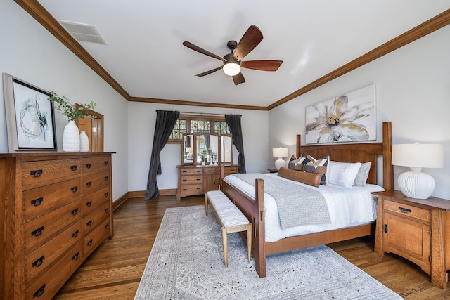 bedroom with visible vents, ornamental molding, baseboards, and wood finished floors