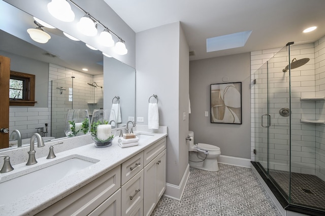 full bathroom featuring a skylight, a stall shower, and a sink
