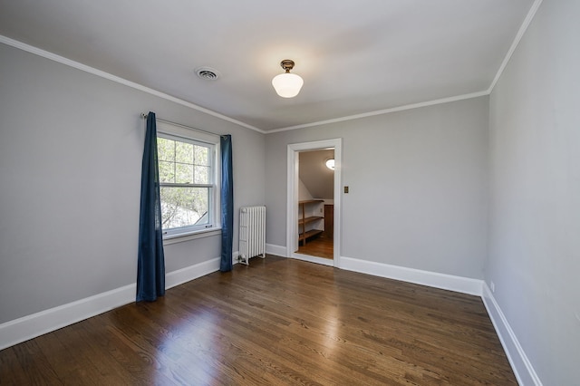 unfurnished room featuring visible vents, ornamental molding, wood finished floors, baseboards, and radiator heating unit