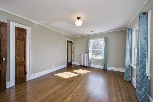 unfurnished room with radiator, baseboards, ornamental molding, and dark wood-type flooring