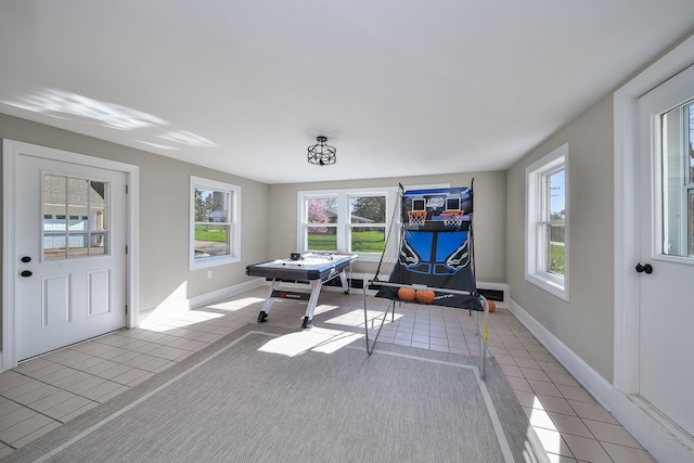 playroom featuring baseboards and light tile patterned floors
