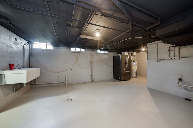 below grade area with a sink and gas water heater