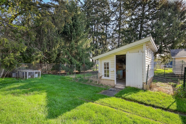 view of outdoor structure featuring fence and an outbuilding