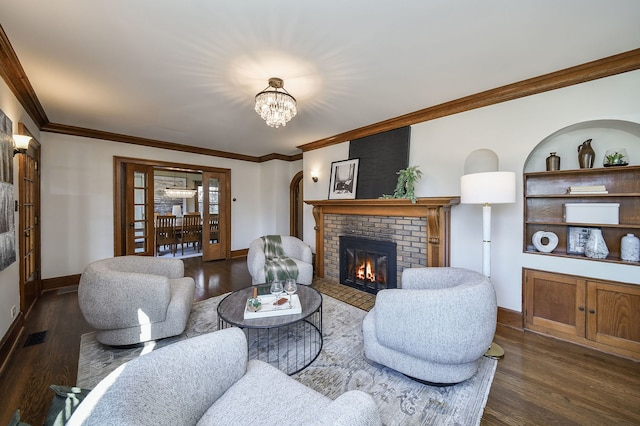 living area featuring ornamental molding, dark wood finished floors, and a fireplace