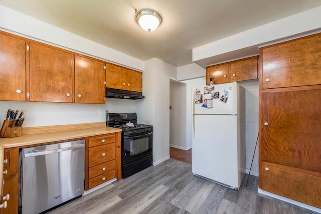 2214 Gilead Ave, Zion, IL 60099 - kitchen with dark wood-style floors, under cabinet range hood, black range with gas cooktop, dishwasher, and freestanding refrigerator