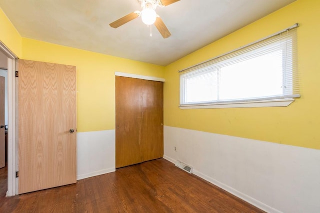 2214 Gilead Ave, Zion, IL 60099 - unfurnished bedroom with a closet, a ceiling fan, visible vents, baseboards, and wood finished floors