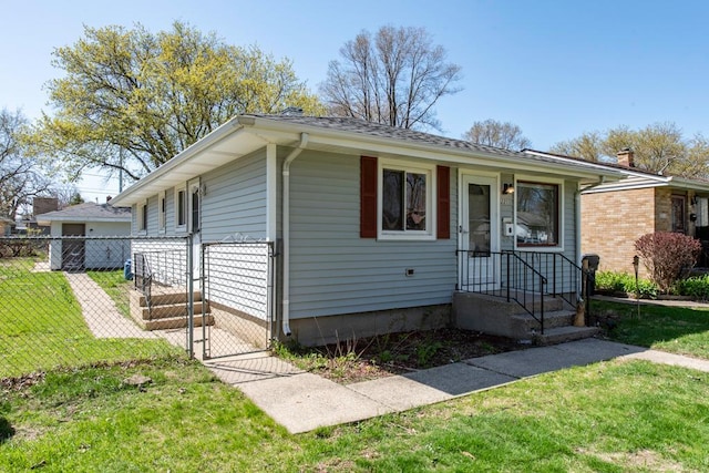 2214 Gilead Ave, Zion, IL 60099 - bungalow-style home with a front lawn, fence, and a gate