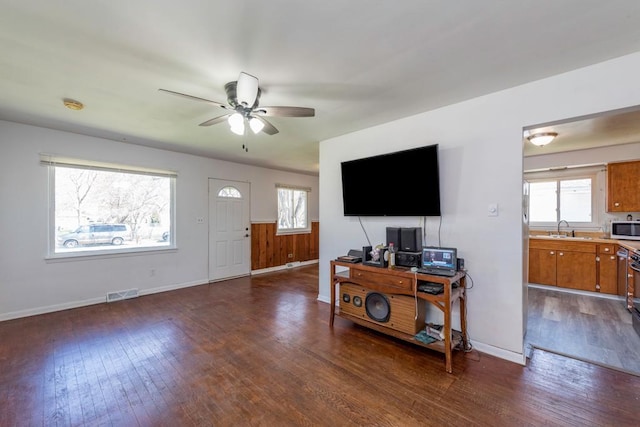 2214 Gilead Ave, Zion, IL 60099 - living area featuring dark wood-type flooring, visible vents, plenty of natural light, and a ceiling fan
