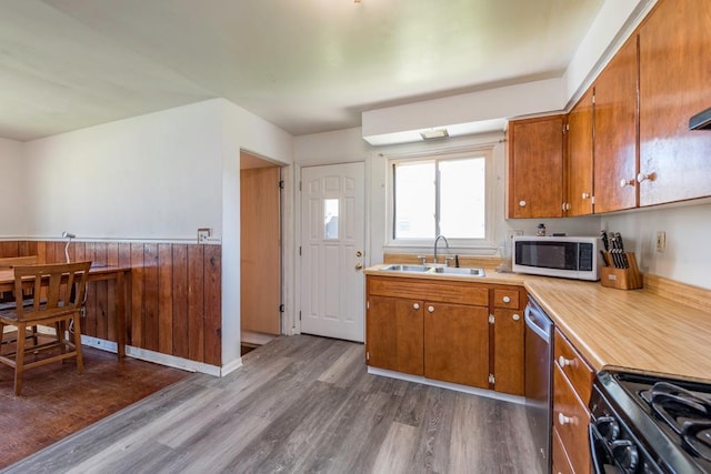 2214 Gilead Ave, Zion, IL 60099 - kitchen with white microwave, brown cabinetry, dark wood-style flooring, gas stove, and a sink