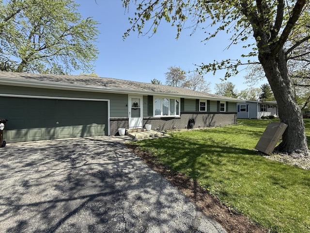 13 Green St, Fisher, IL 61843 - single story home with brick siding, driveway, a garage, and a front yard