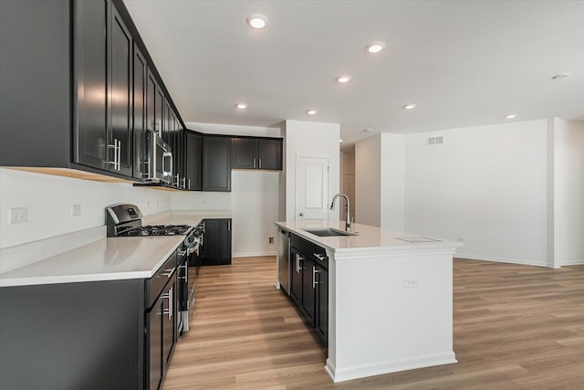 4 Harborside Way, Hawthorn Woods, IL 60047 - kitchen featuring light wood finished floors, a sink, stainless steel appliances, a center island with sink, and light countertops