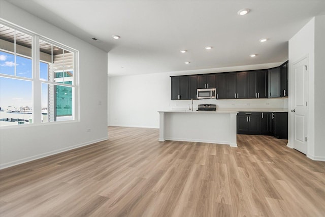 4 Harborside Way, Hawthorn Woods, IL 60047 - kitchen featuring stove, light countertops, light wood finished floors, and stainless steel microwave