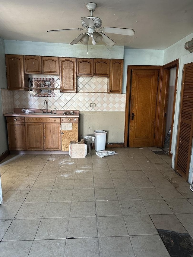 kitchen featuring light tile patterned flooring, brown cabinets, and decorative backsplash