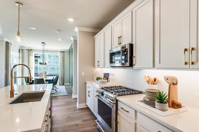 3 Harborside Way, Hawthorn Woods, IL 60047 - kitchen featuring appliances with stainless steel finishes, light countertops, backsplash, a sink, and pendant lighting