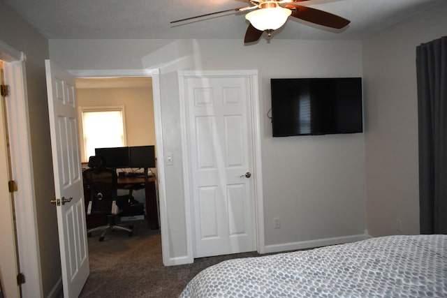 bedroom with a ceiling fan, dark carpet, and a closet