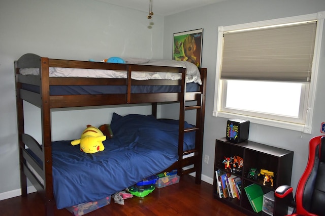 bedroom with baseboards and wood finished floors