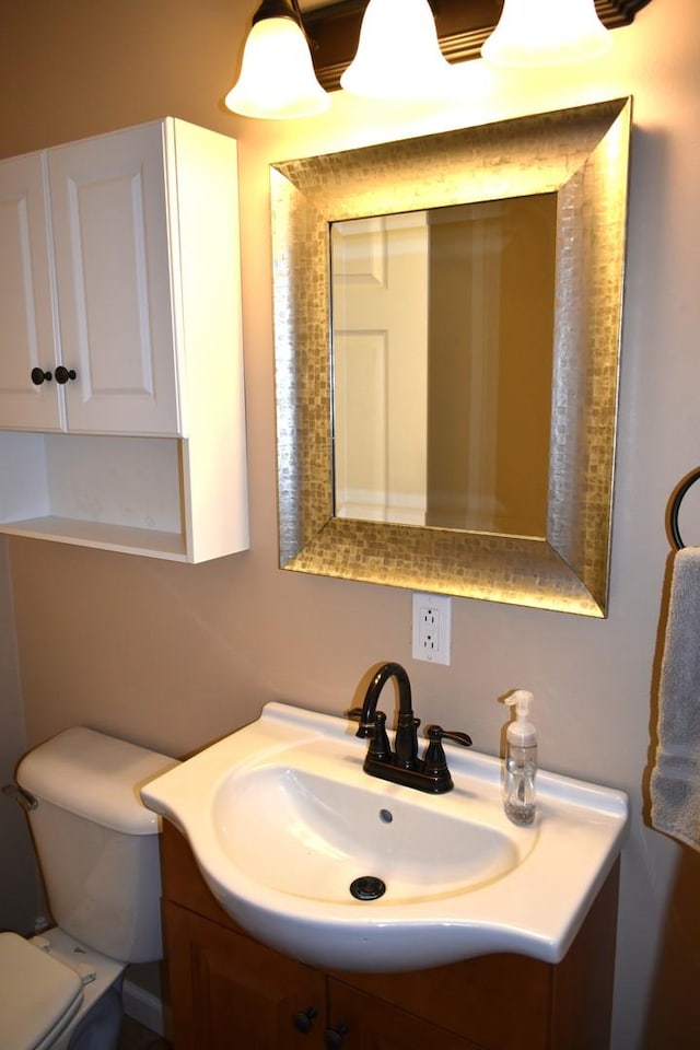 bathroom with toilet and vanity