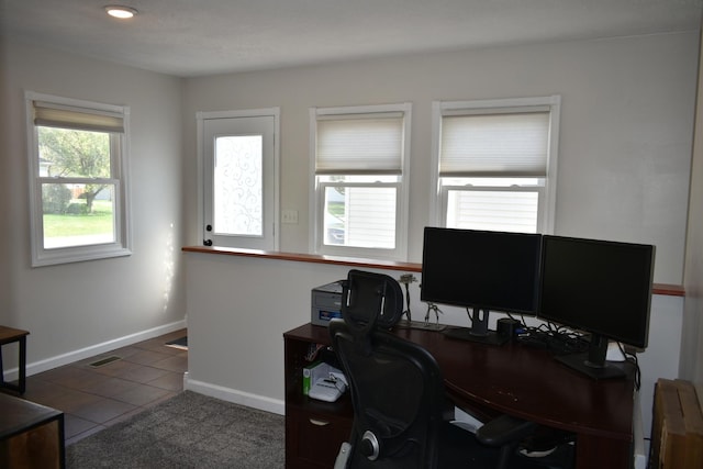 office area featuring baseboards, visible vents, and tile patterned floors
