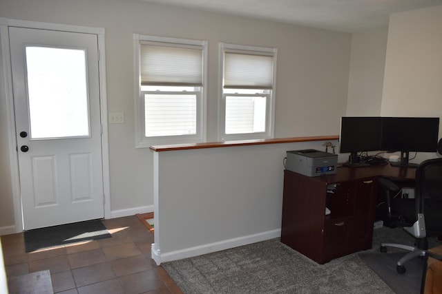 office space featuring dark tile patterned floors and baseboards