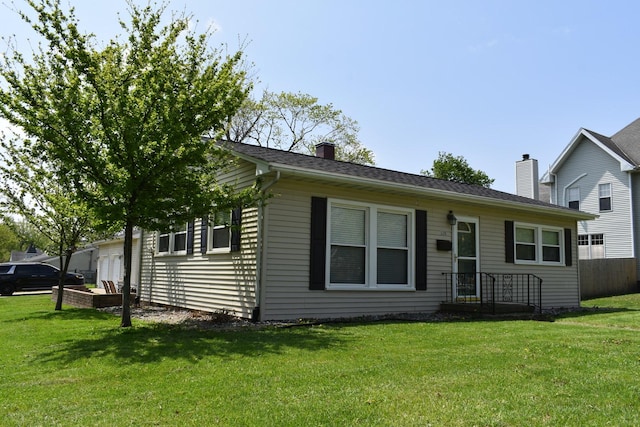 view of front facade featuring fence, a front lawn, and a chimney