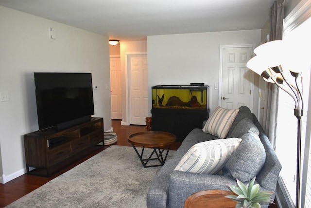 living room with dark wood-style flooring and baseboards