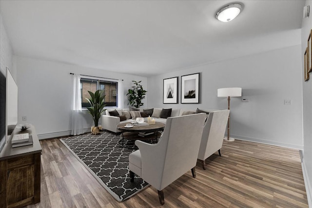 dining space featuring wood finished floors and baseboards