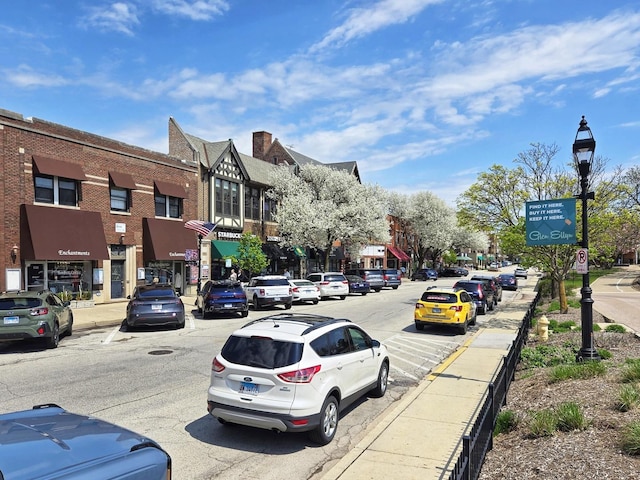 view of road featuring curbs, sidewalks, and street lights