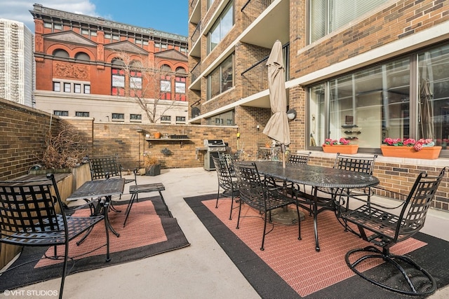 1555 N Sandburg Ter Unit 115K, Chicago, IL 60610 - view of patio with outdoor dining area and a grill