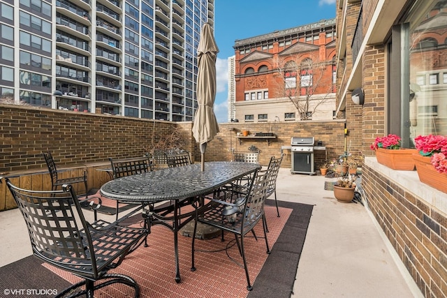 1555 N Sandburg Ter Unit 115K, Chicago, IL 60610 - view of patio featuring outdoor dining space and a grill